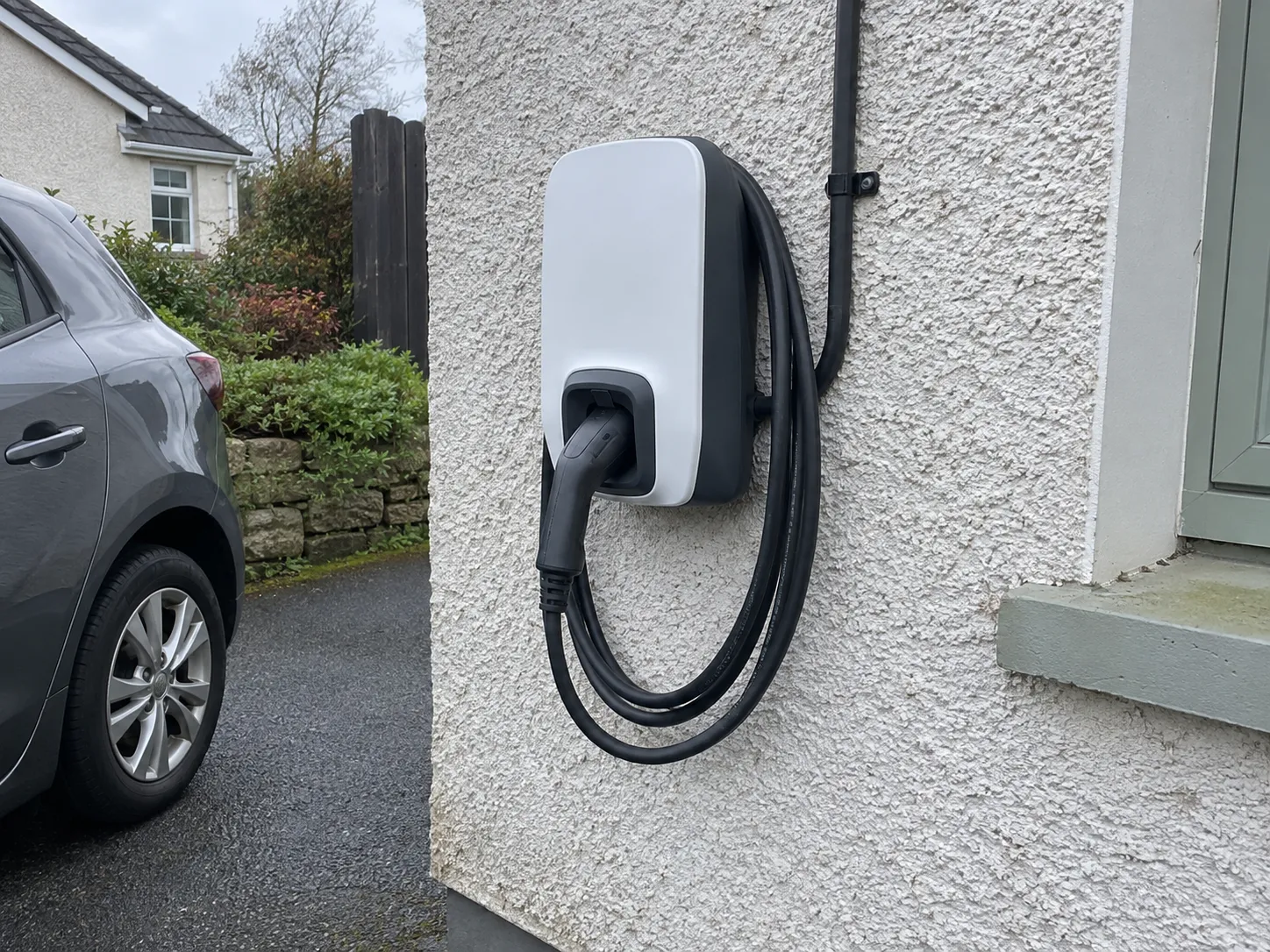Illustrative home EV charger mounted on an exterior wall (AI-generated)