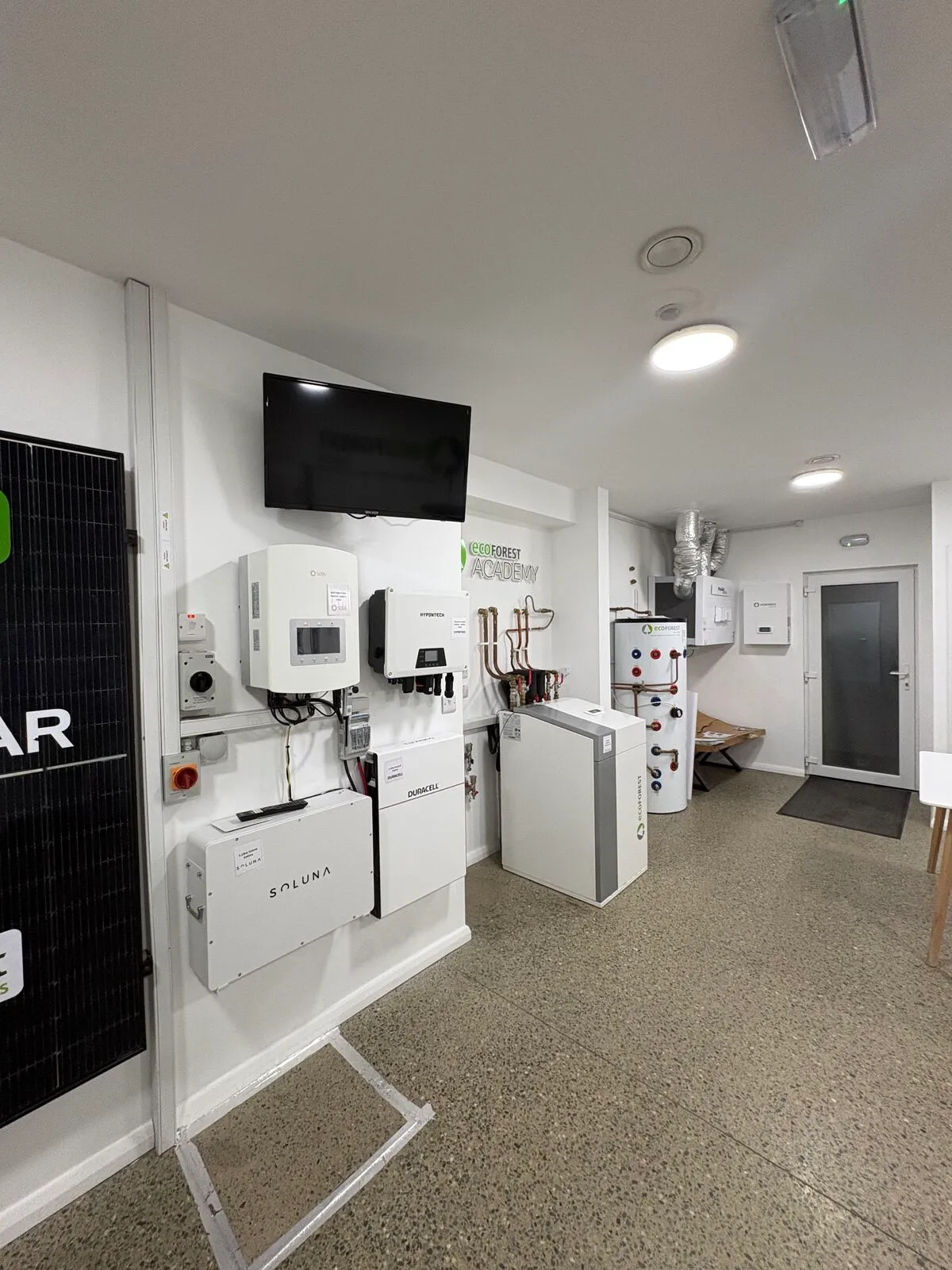 Efficient Renewables showroom with solar inverters and heat pump units on display